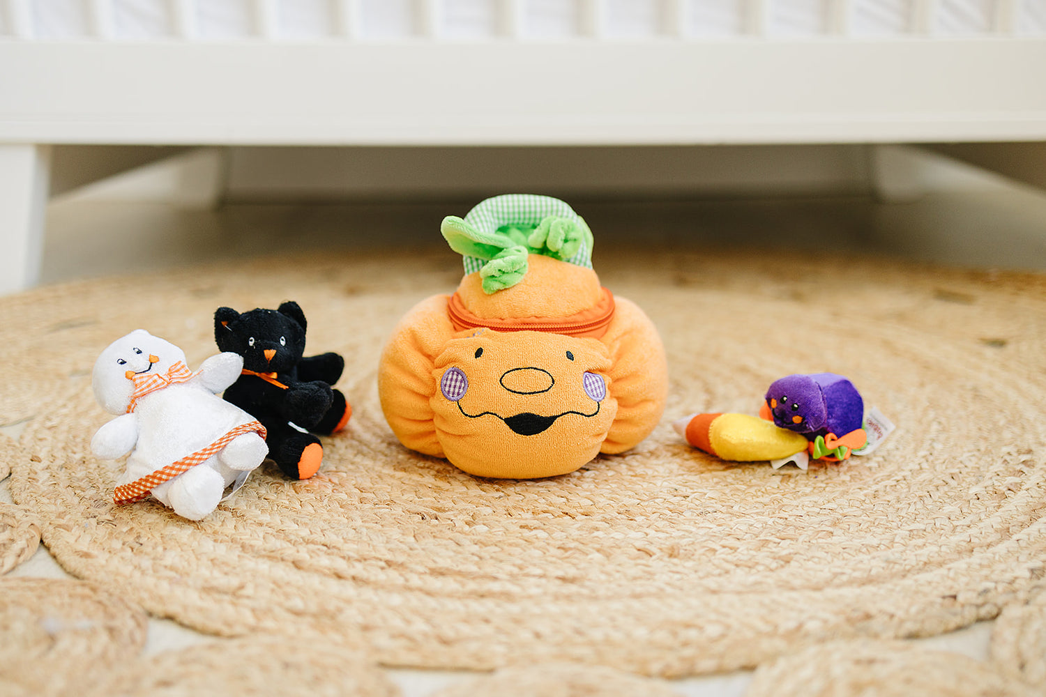 Set of colorful plush toys on a woven mat