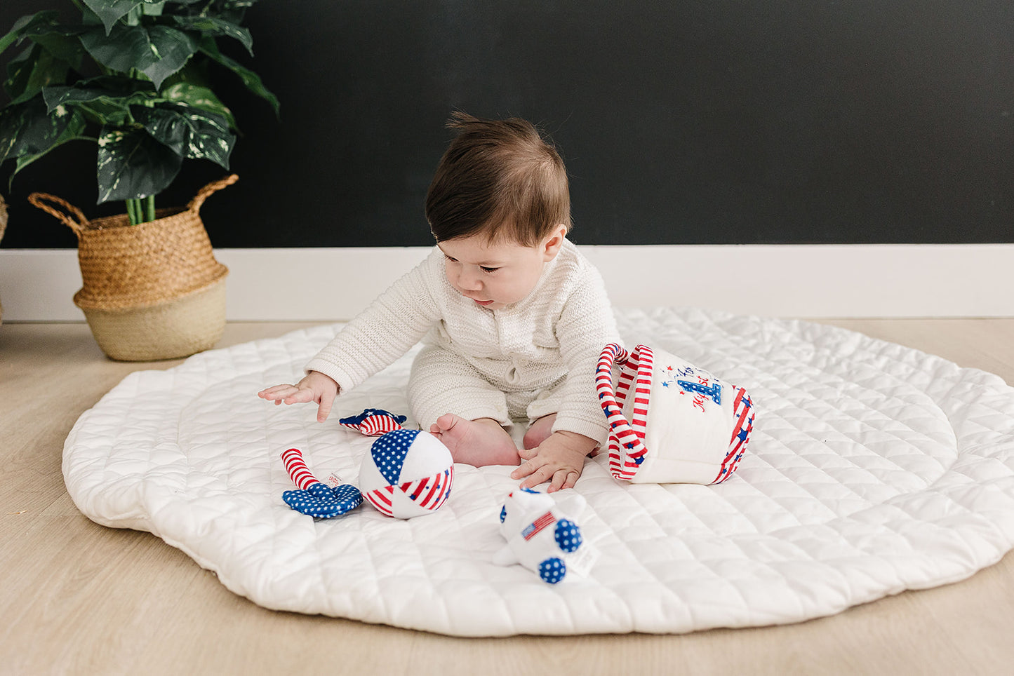 Baby playing with Fourth of July baby toys