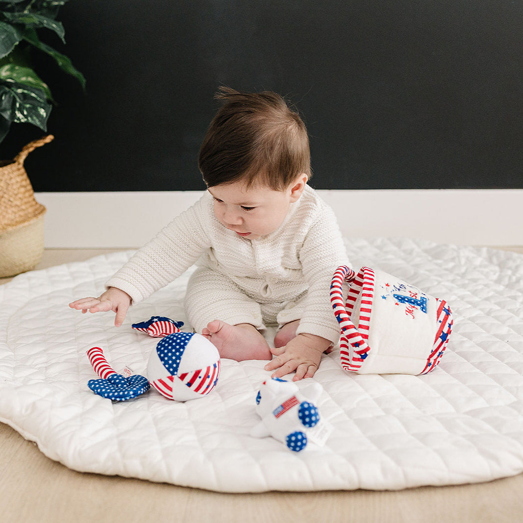 Baby playing with Fourth of July baby toys