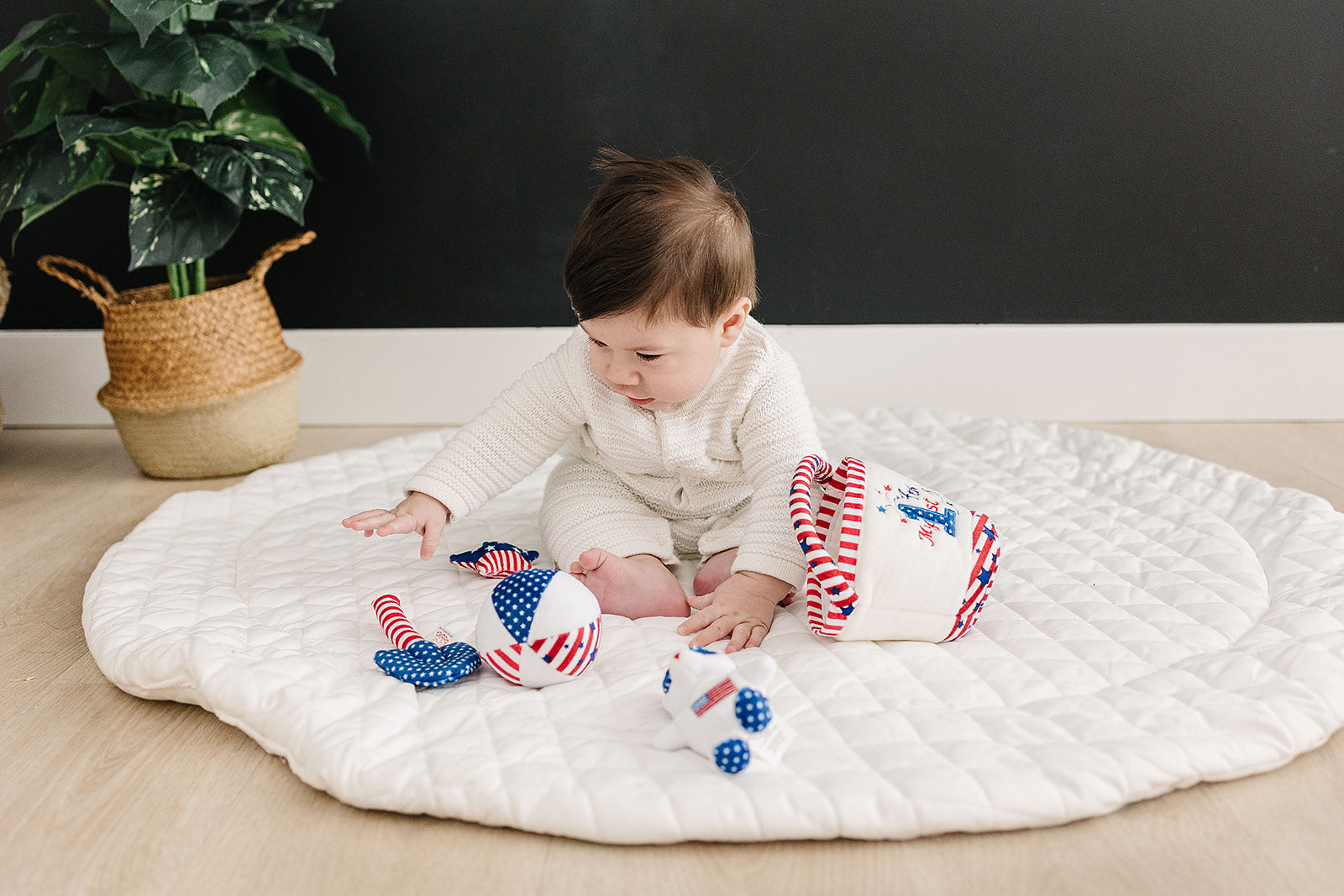 Baby playing with Fourth of July baby toys